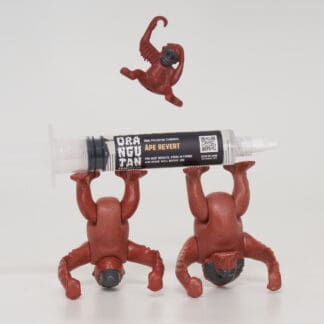 Orangutan Trading Co spore syringe with three toy orangutans playing with it, white background