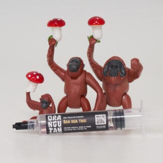 Orangutan Trading Co spore syringe with three toy orangutans playing with it, white background