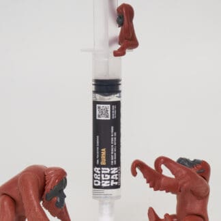 Orangutan Trading Co spore syringe with three toy orangutans playing with it, white background