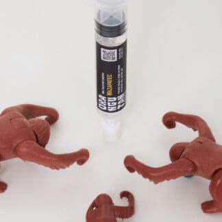 Orangutan Trading Co spore syringe with three toy orangutans playing with it, white background