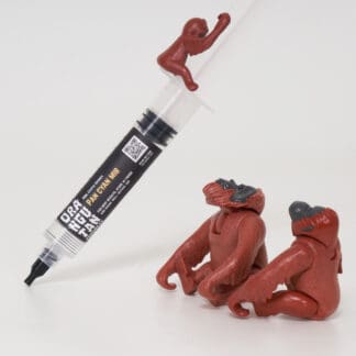 Orangutan Trading Co spore syringe with three toy orangutans playing with it, white background