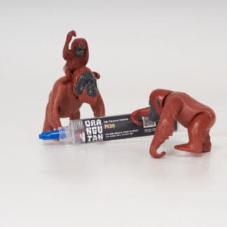 Orangutan Trading Co spore syringe with three toy orangutans playing with it, white background