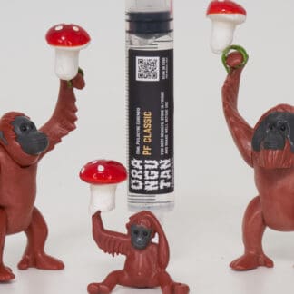 Orangutan Trading Co spore syringe with three toy orangutans playing with it, white background