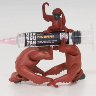 Orangutan Trading Co spore syringe with three toy orangutans playing with it, white background