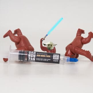 Orangutan Trading Co spore syringe with three toy orangutans playing with it, white background