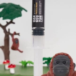 Orangutan Trading Co spore syringe with two toy orangutans playing with it, white background