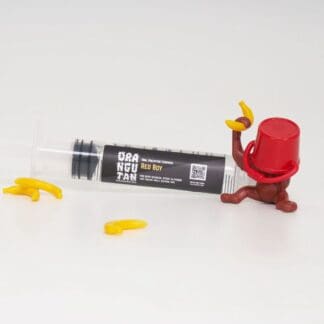 Orangutan Trading Co spore syringe with one toy orangutan playing with it, white background