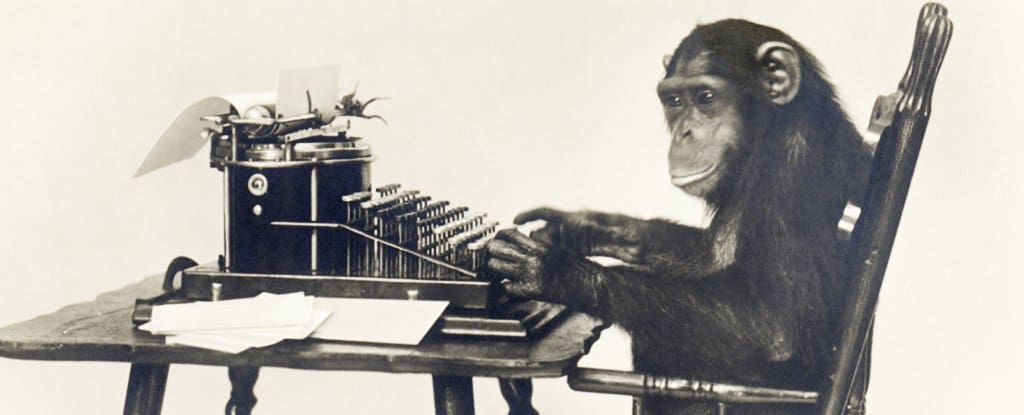 Monkey writing on an old-fashioned typewriter